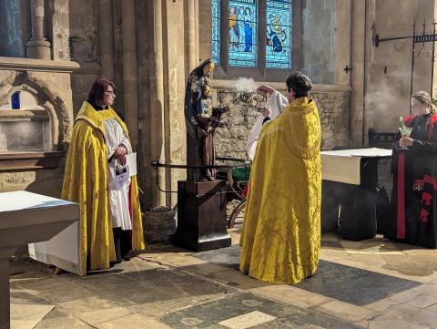 The Dean, wearing a gold cope, blesses the Eugene Ball statue and plinth wit incense during its installation on Easter Day 2024