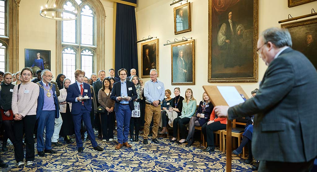 Professor McDonald addresses guests in the McKenna room