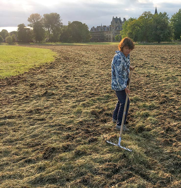 Catriona Bass raking out some areas where the hay was too thick