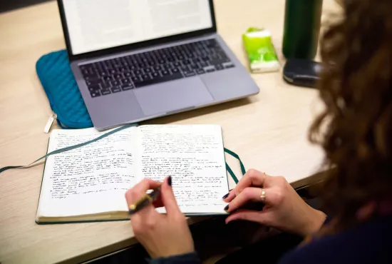 A student writing in a notebook