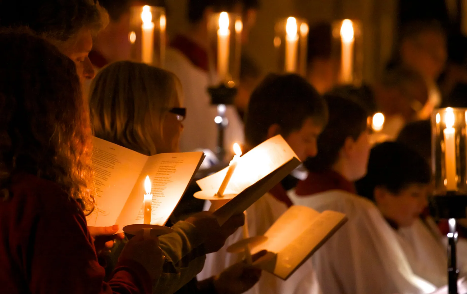 Choir and congregation singing by candlelight