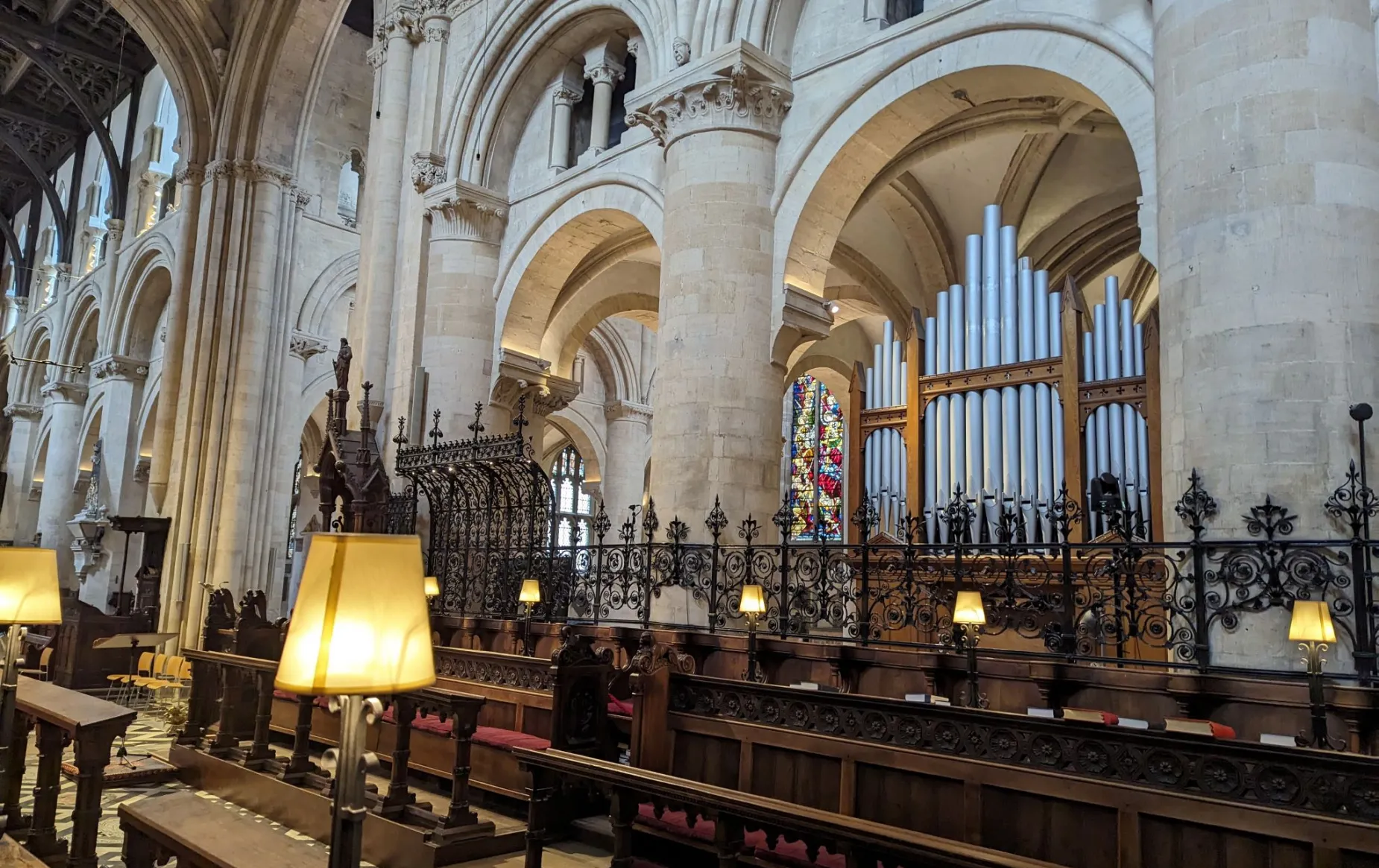 A view of the Chancel, with the former chancel organ visible under the arches