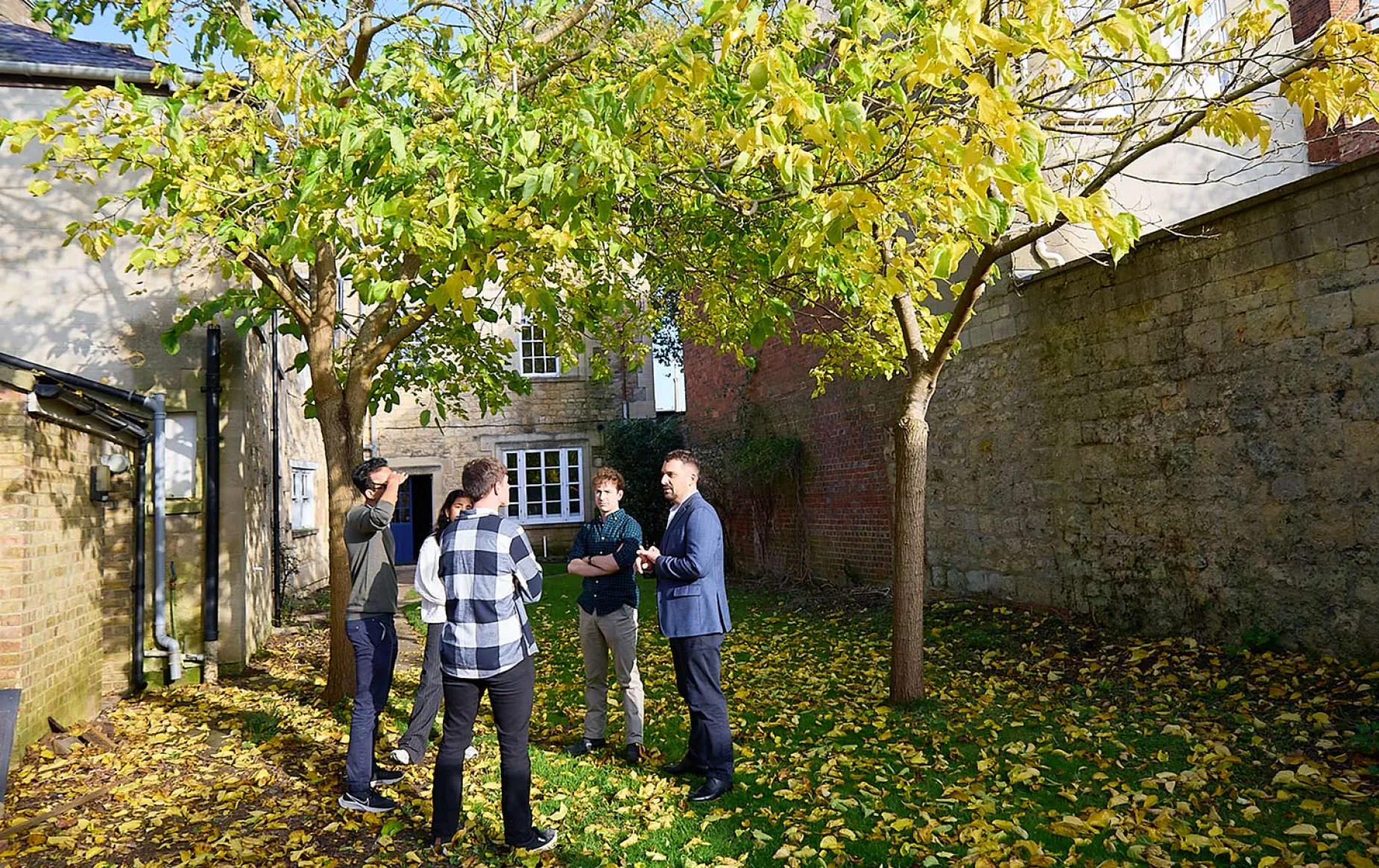 students in discussion with the Centre Director at the rear of 37 St Giles