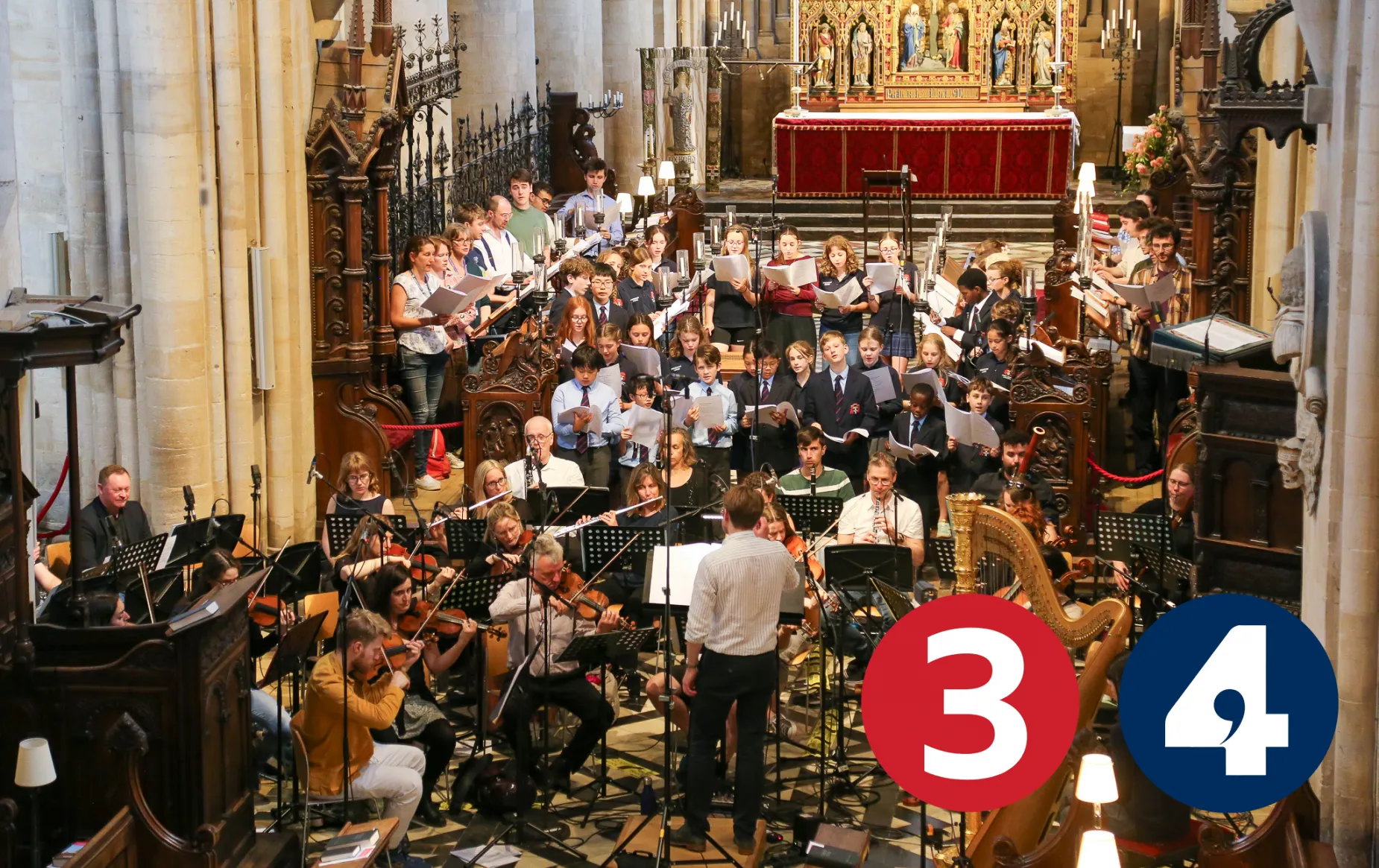 Peter holder conducts the Cathedral Choir, Frideswide voices and an orchestra in the Cathedral, surrounded by recording microphones