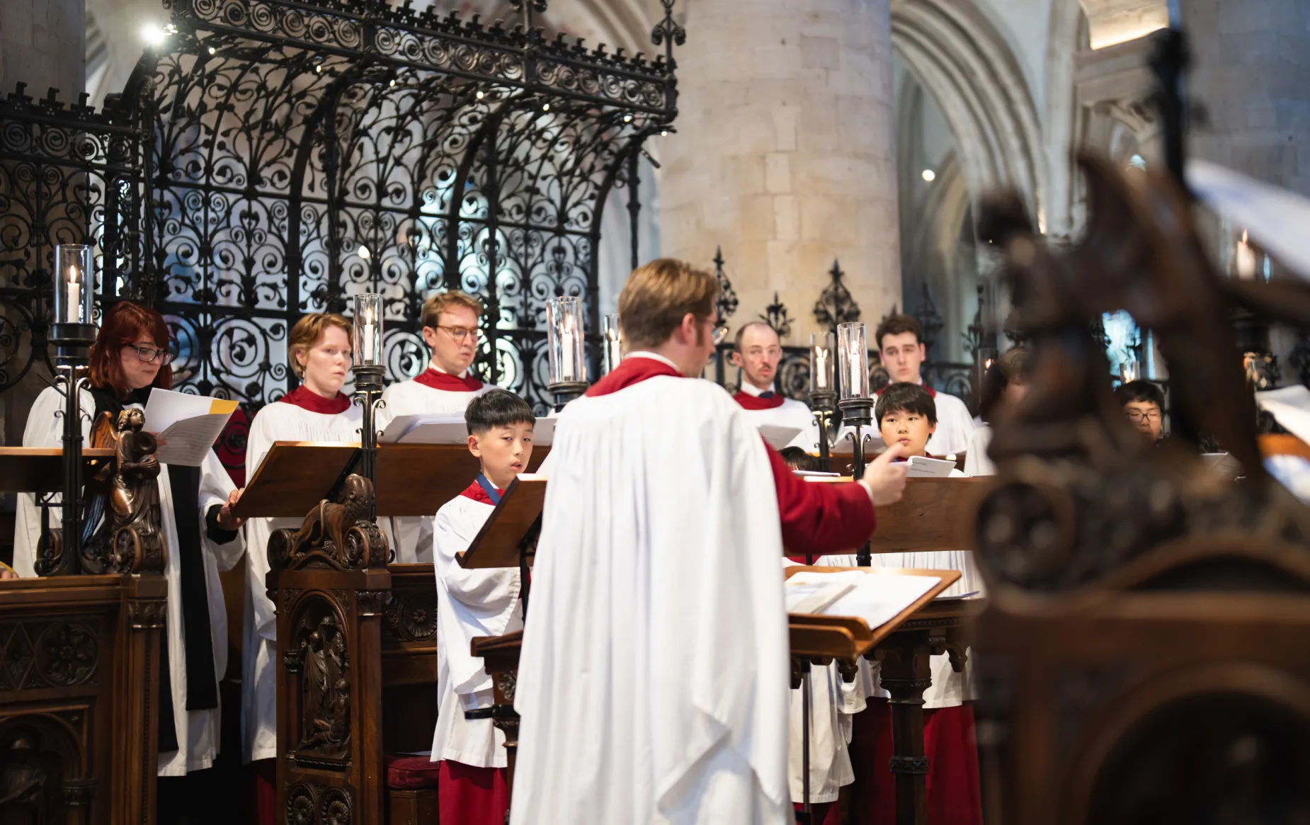 Peter Holder conducts the choir during the 500th anniversary Vespers service