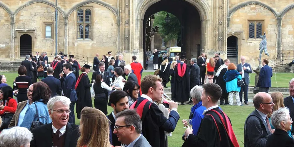 Graduands and their friends and family celebrating graduation in Tom Quad