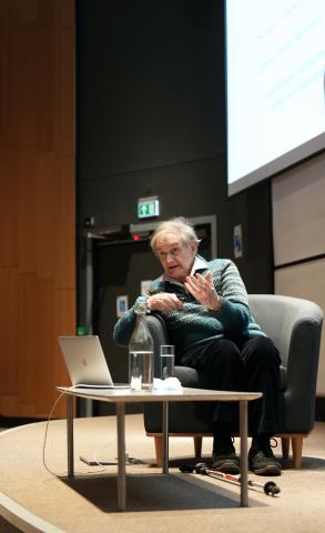 Sir Roger Penrose delivering a talk to an auditorium