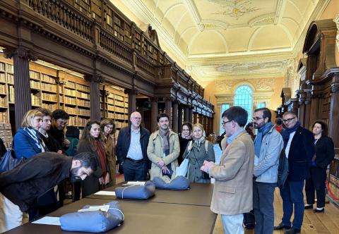 The French Ambassador and her team being shown the Upper Library's French treasures