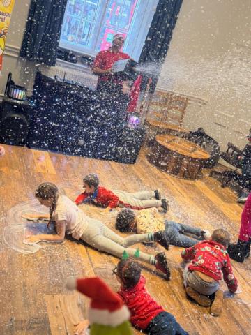 Children at the Christmas party making snow angels
