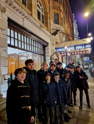 The Cathedral choristers in their coats outside the entrance of Wigmore Hall, looking very excited about the beginning of the Choir's anniversary year