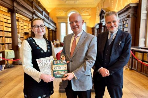 Oxford Chancellor Lord Hague being presented a book by Liv Bennison, DPhil student