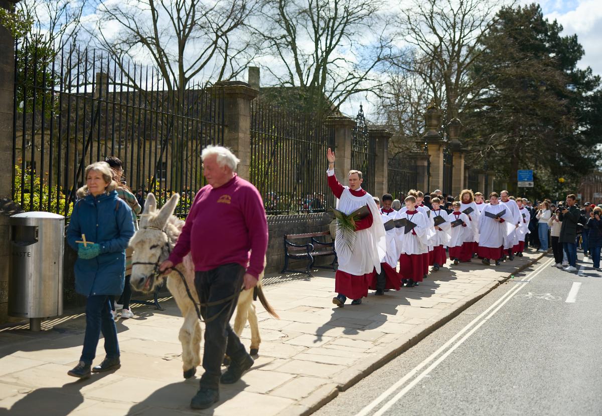 Monty the donkey leads Christ church Cathedral Choir down st aldates during their Palm Sunday procession