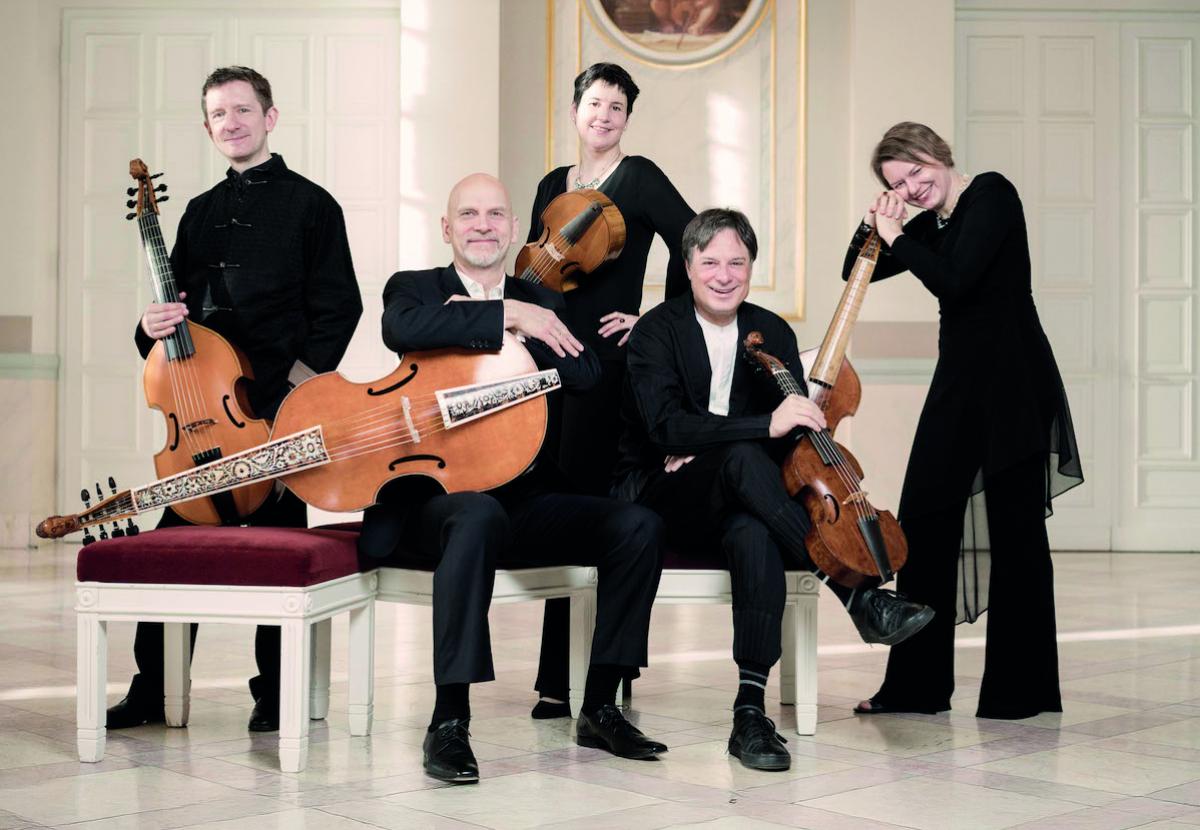 Phantasm consort posed with their viols in a neoclassical ballroom