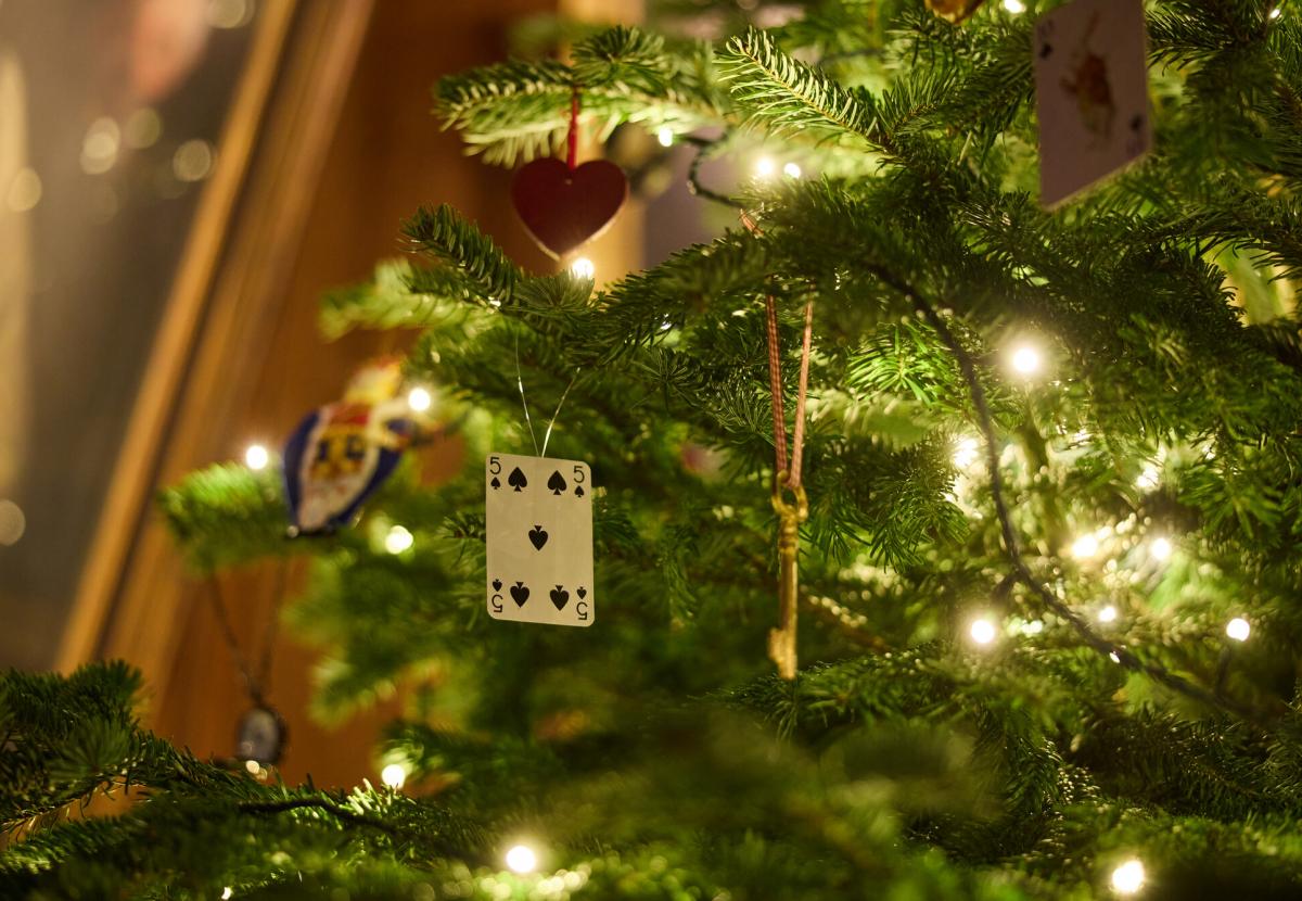 A close up of a Christmas tree in Hall with Alice in Wonderland themed decorations