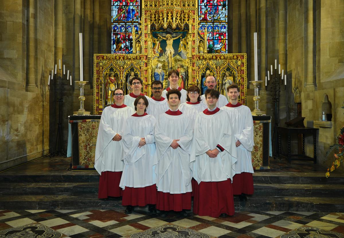 The clerks of the 2025/26 Cathedral choir, arranged in their robes by the high altar in the Cathedral.