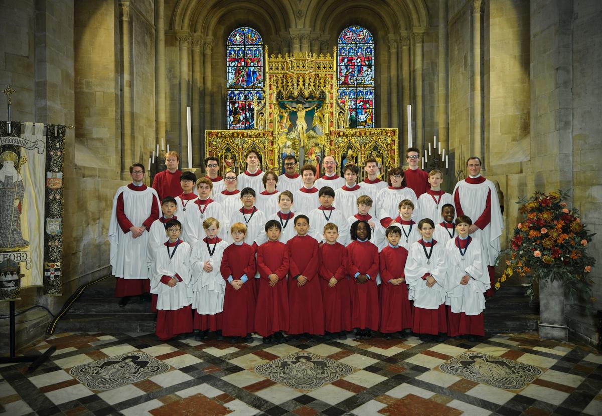 The 2025/26 cathedral choir, group portrait in choir robes by the high altar in the cathedral