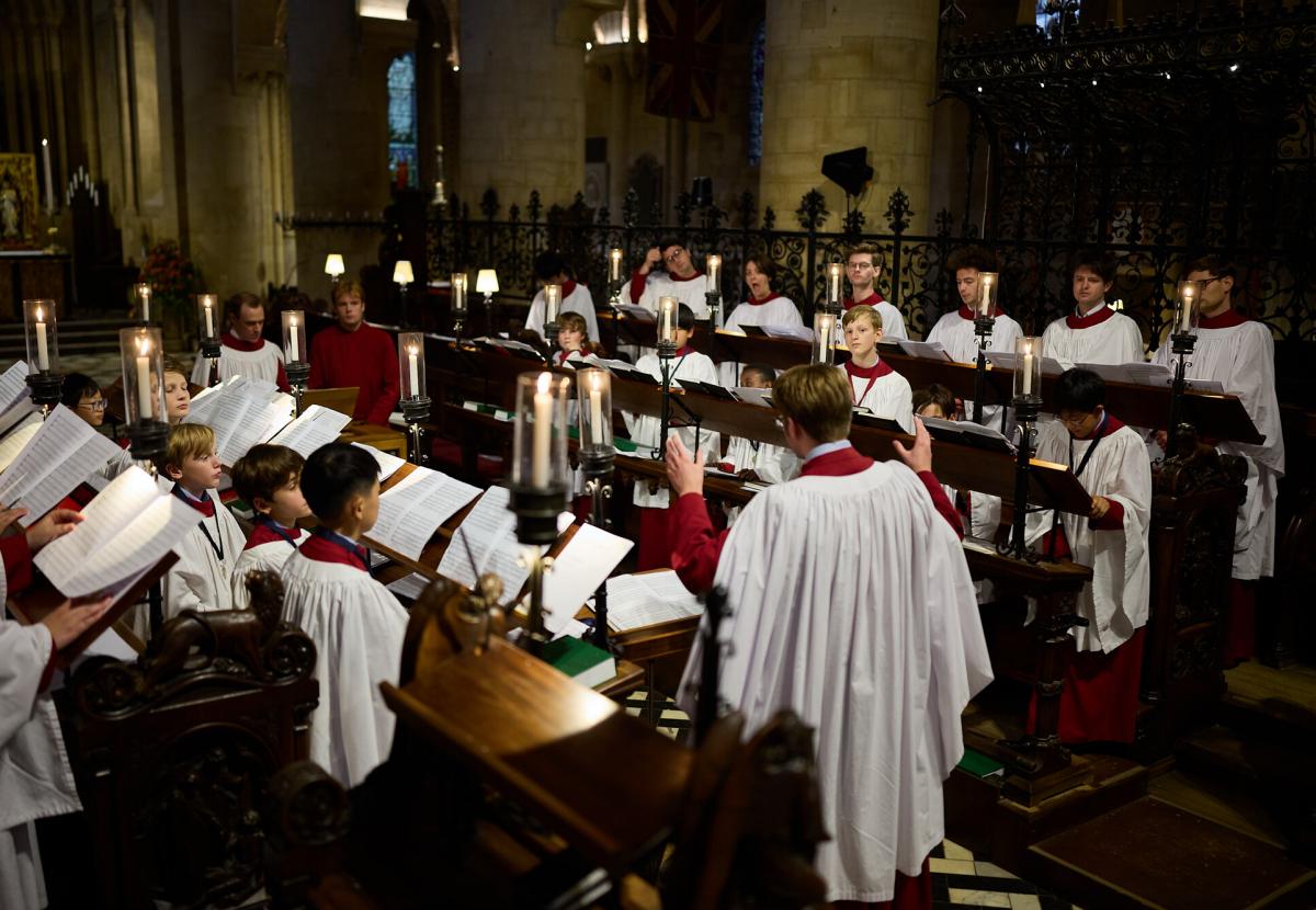 The 2025/26 Cathedral Choir singing in the chancel, fully robed.
