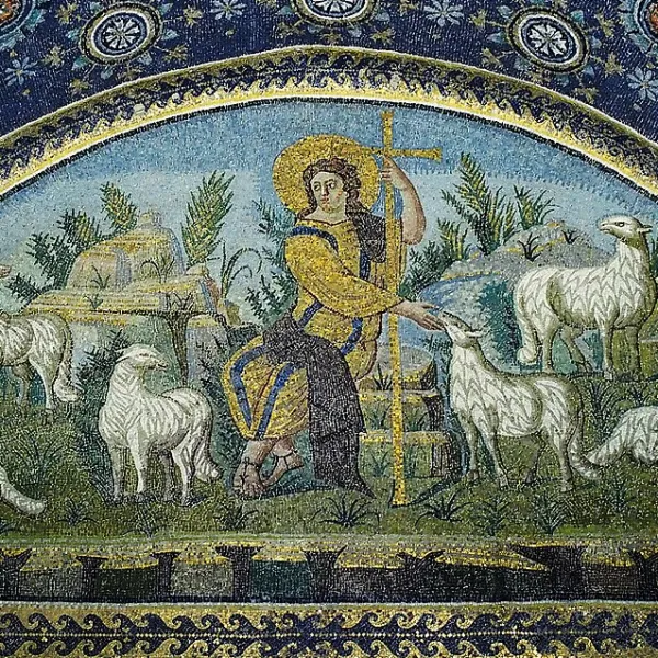 A fifth century Italian mosaic depicting Jesus as the good shepherd. Jesus wears a yellow robe and sits on a rock, surrounded by trees and sheep.