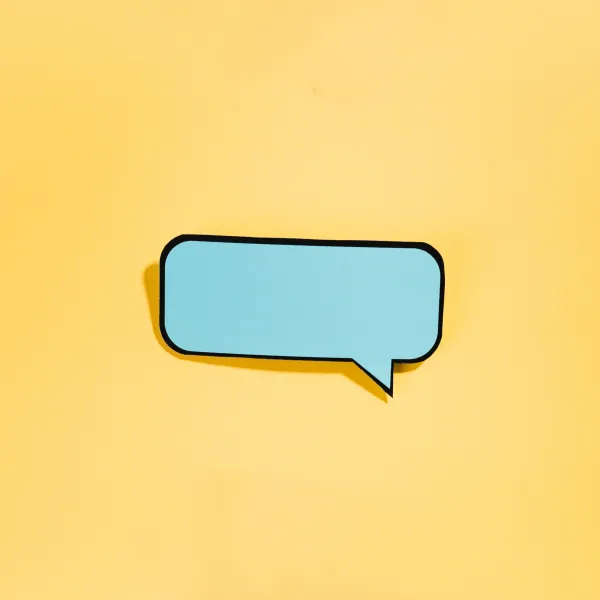  blue speech bubble on a yellow paper background