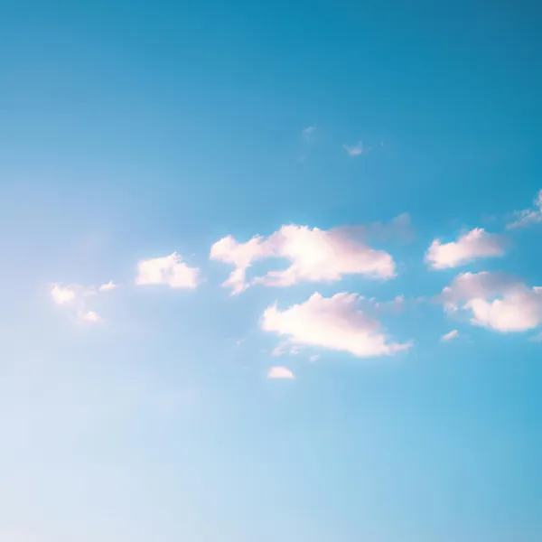 A few clouds in a blue sky.