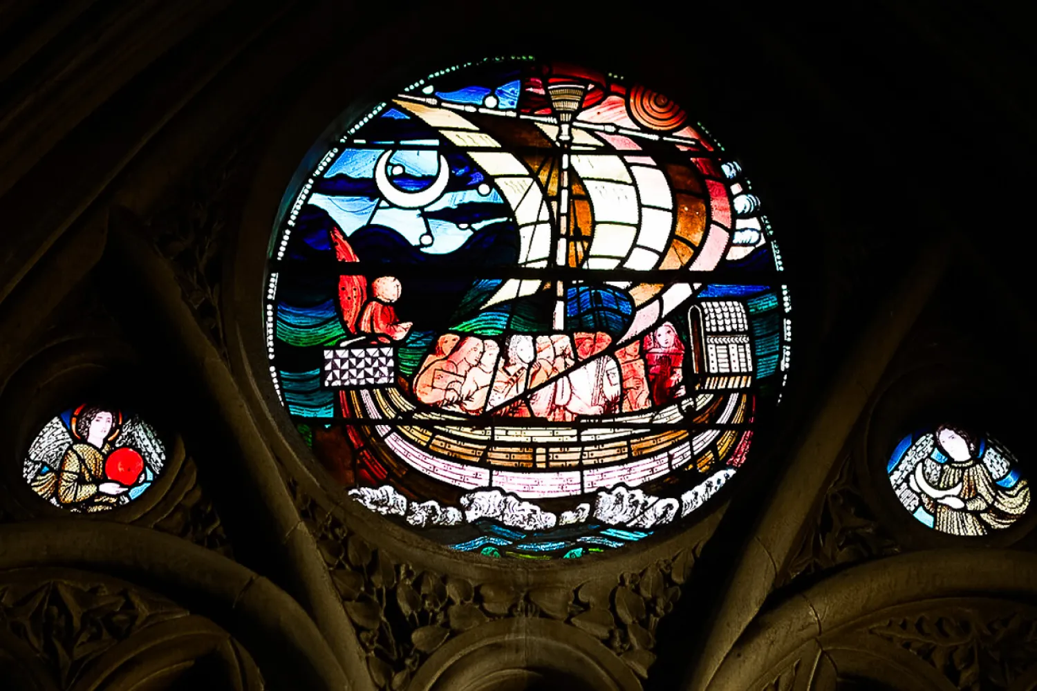 A pane from the Edward Burne-Jones stained glass window in the Cathedral depicting scenes from the life of St Frideswide. in this circular panel, St Frideswide sails on a boat sent from God to escape her suitor, King Algar of Leicester