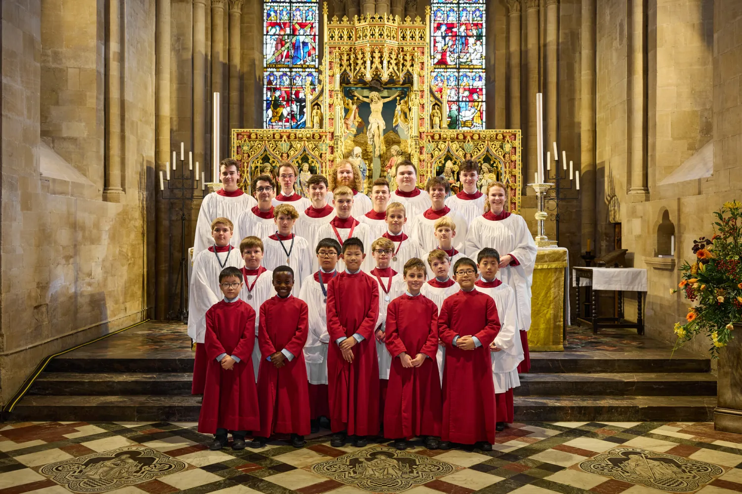 The Cathedral clerks and choristers standing in front of the high altar in their robes