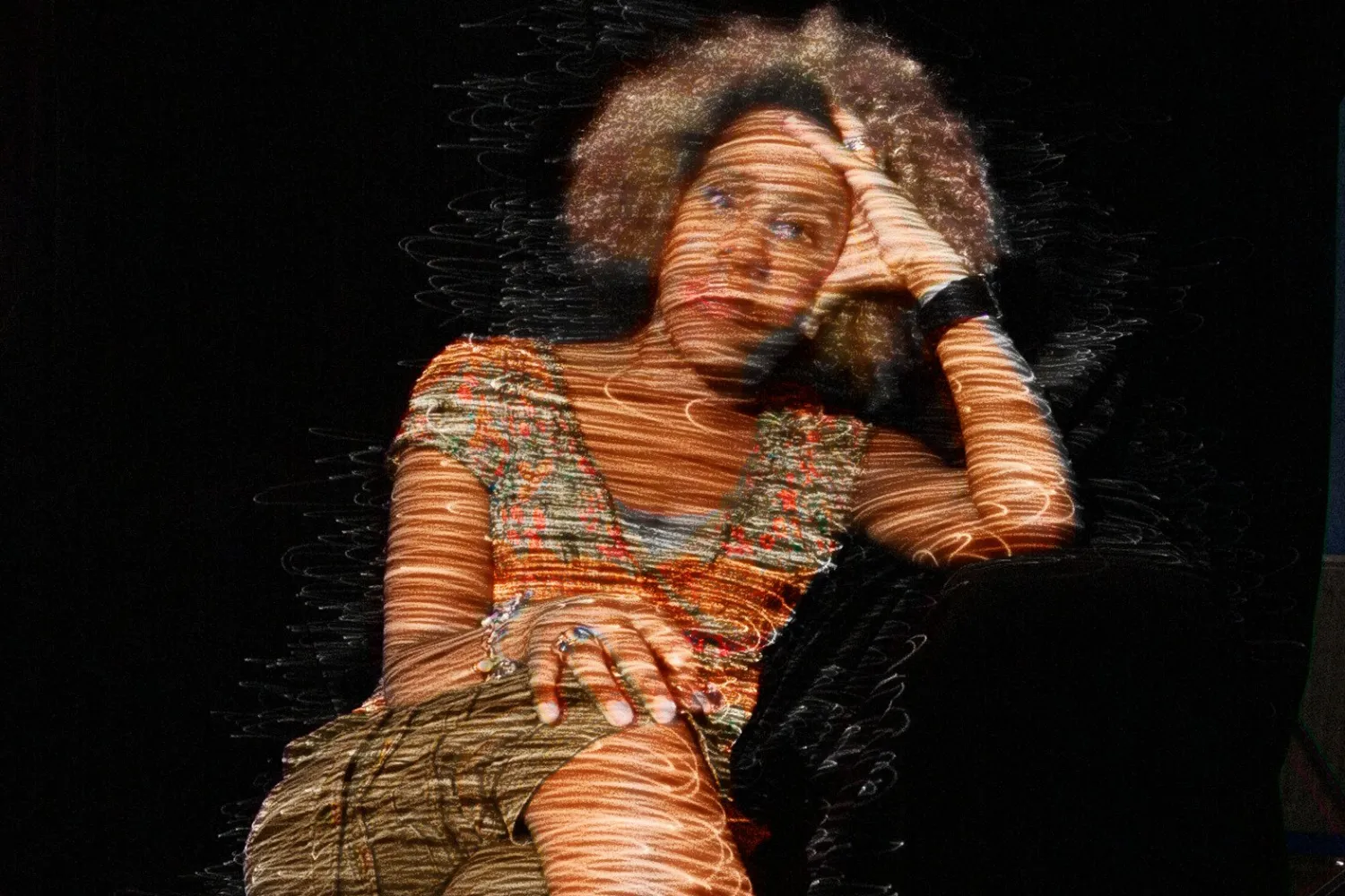 Errollyn Wallen, with soundwave like lines of light projected onto her.