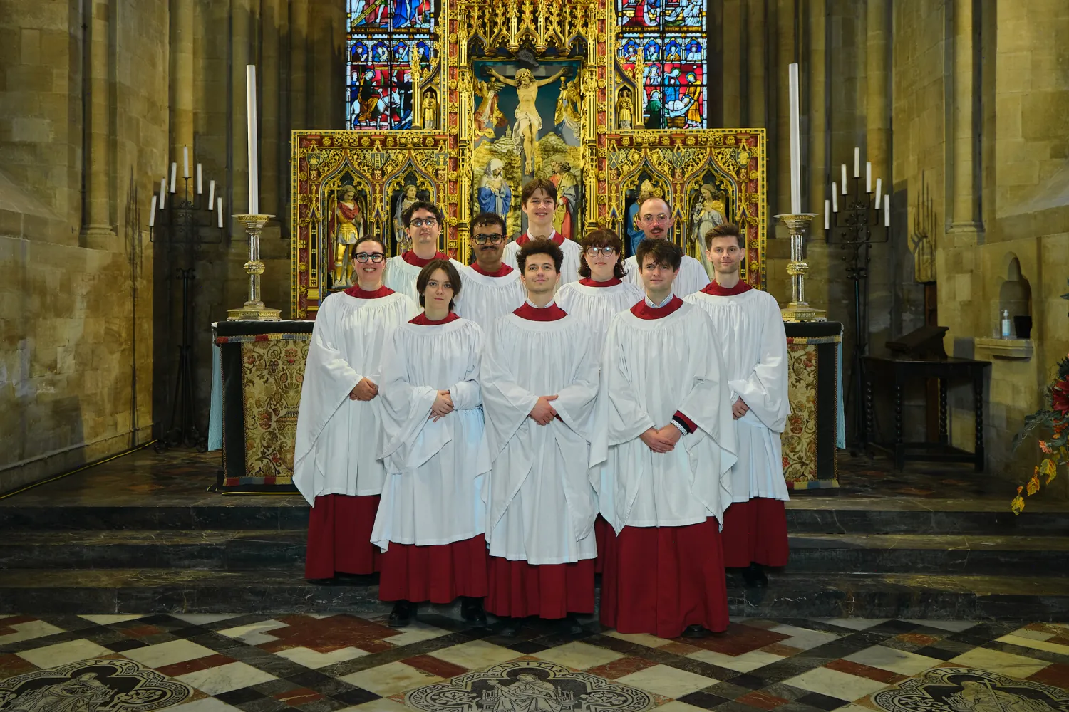 The clerks of the 2025/26 Cathedral choir, arranged in their robes by the high altar in the Cathedral.
