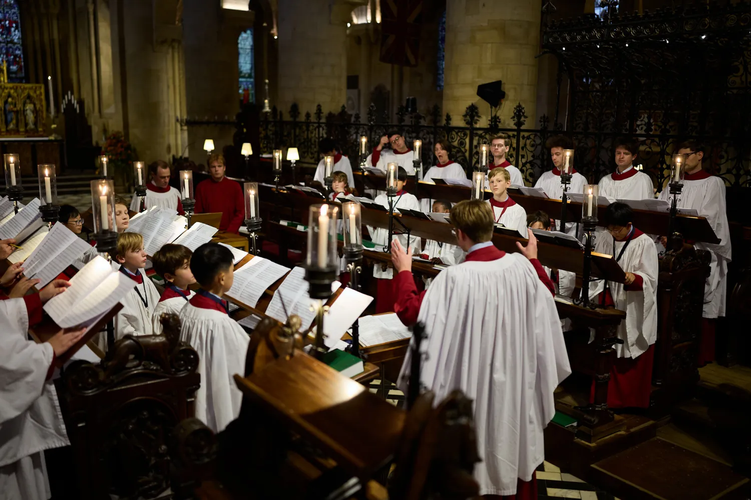 The 2025/26 Cathedral Choir singing in the chancel, fully robed.