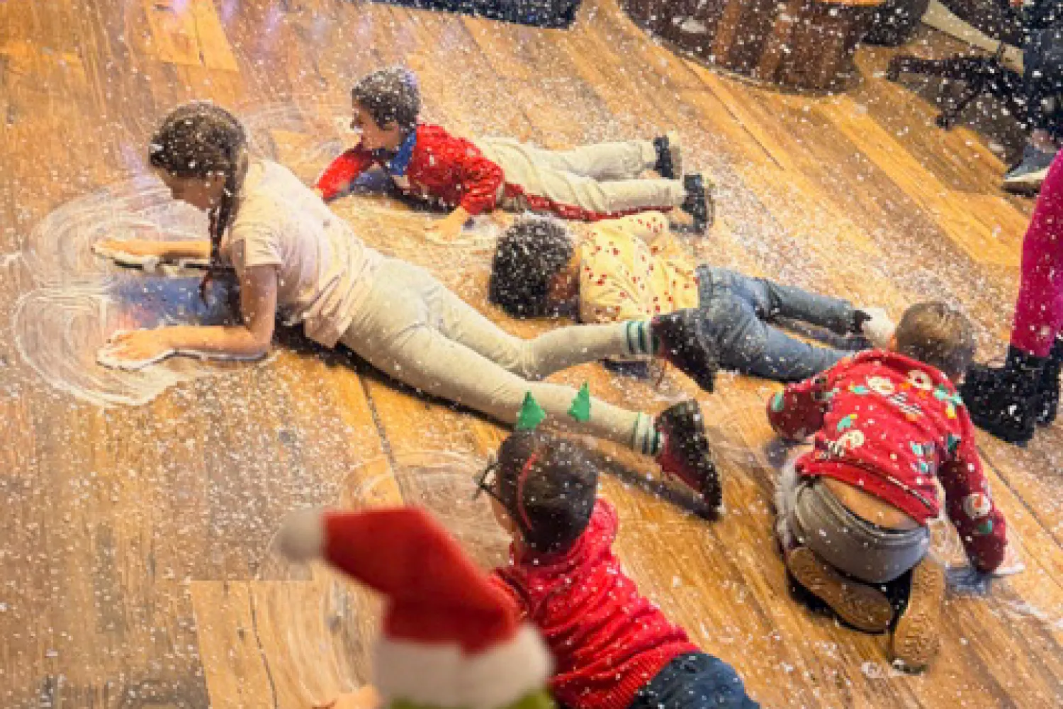 Children at the Christmas party making snow angels
