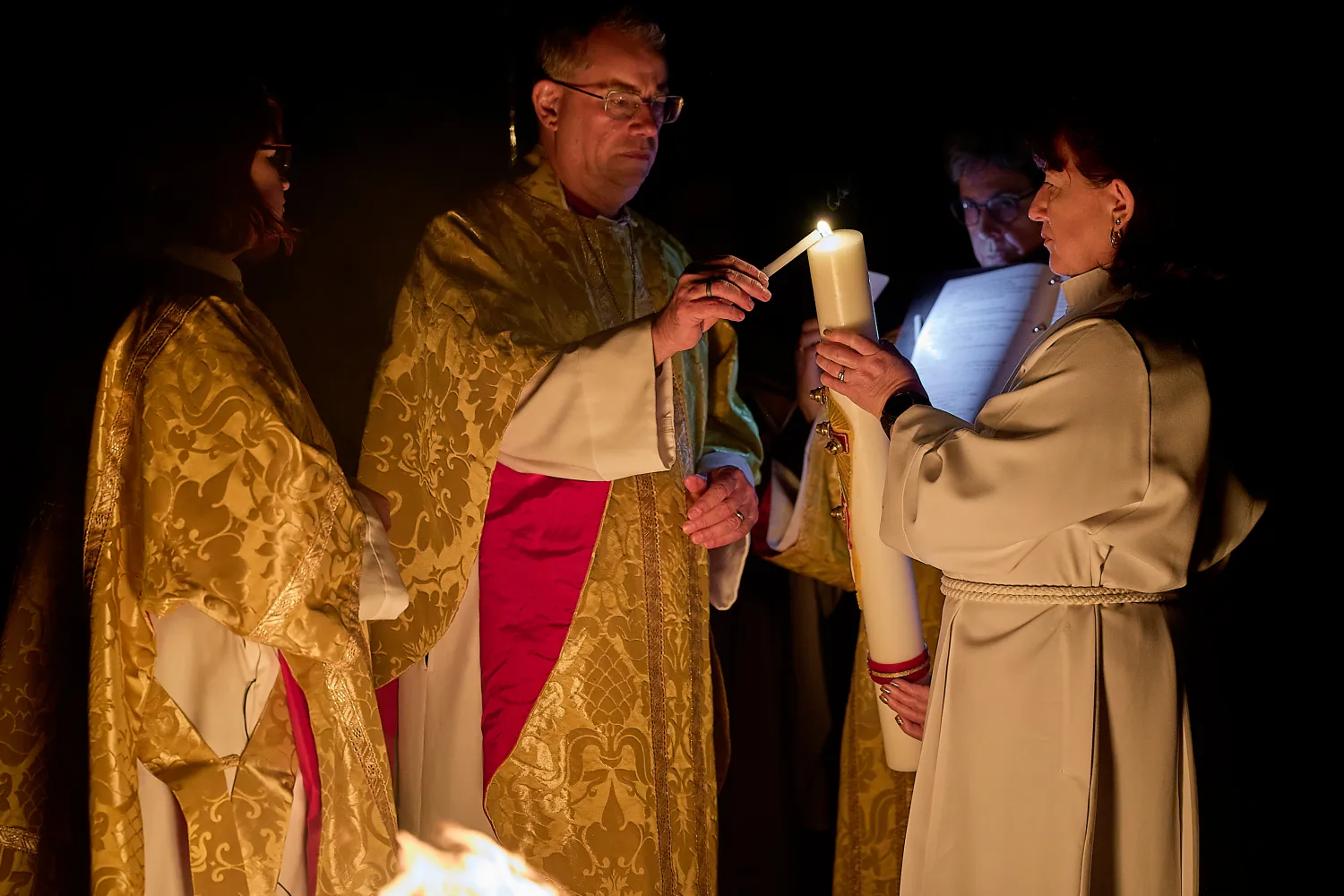 Bishop Steven lights the Paschal Candle at the Easter Vigil service, 2024