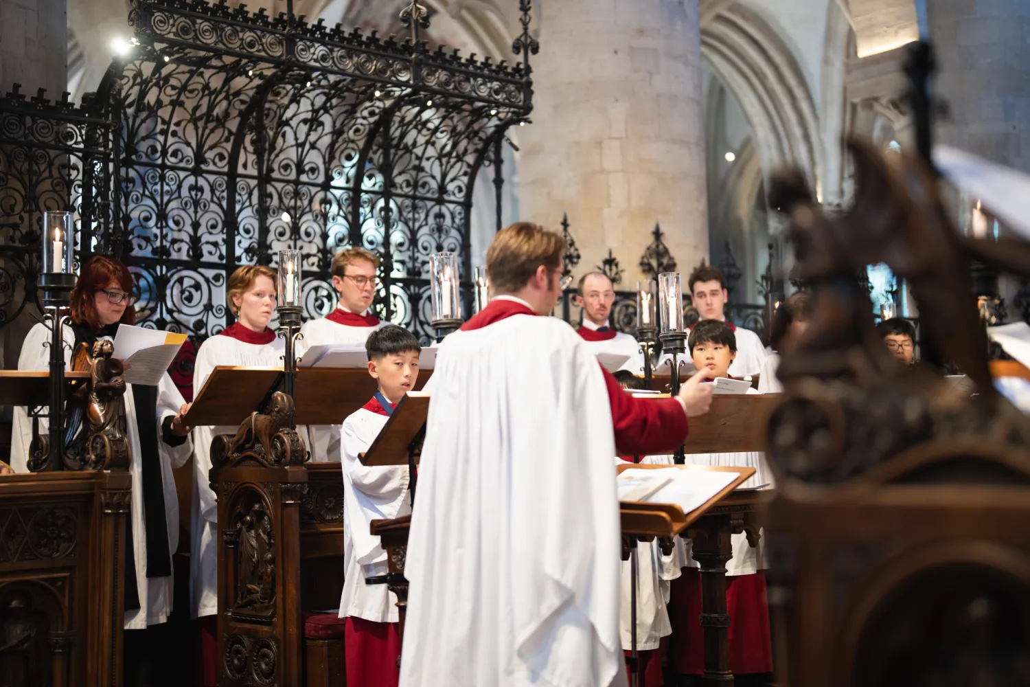 Peter Holder conducts the choir during the 500th anniversary Vespers service