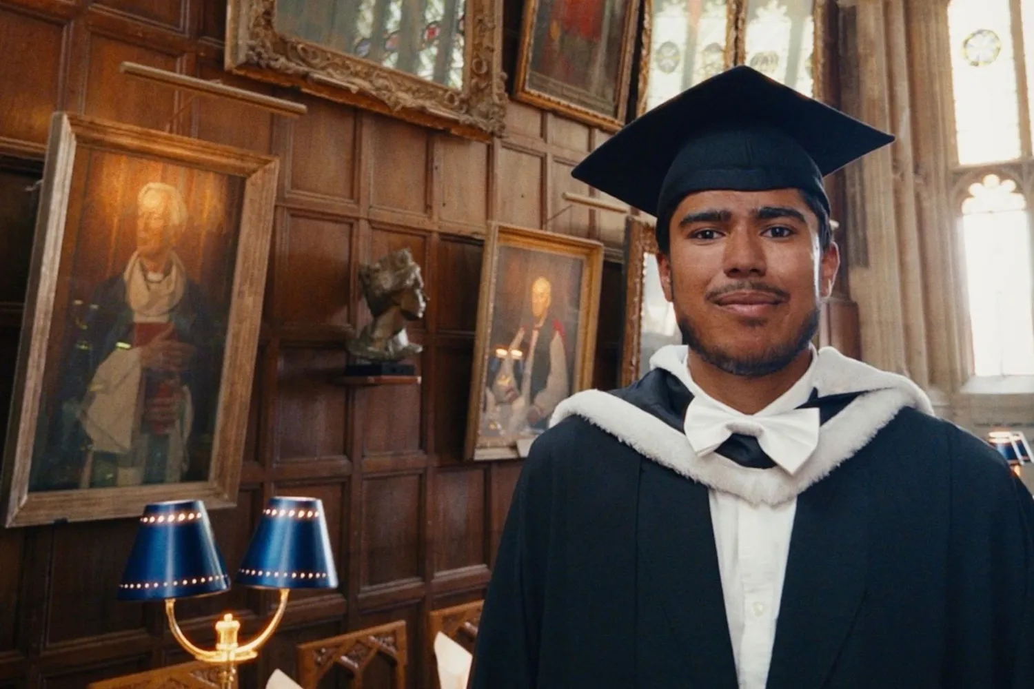 Nayaaz Hashim in academic dress in Christ Church Hall following the completion of his undergraduate degree.