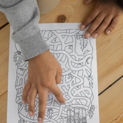 Child examining a picture of a maze
