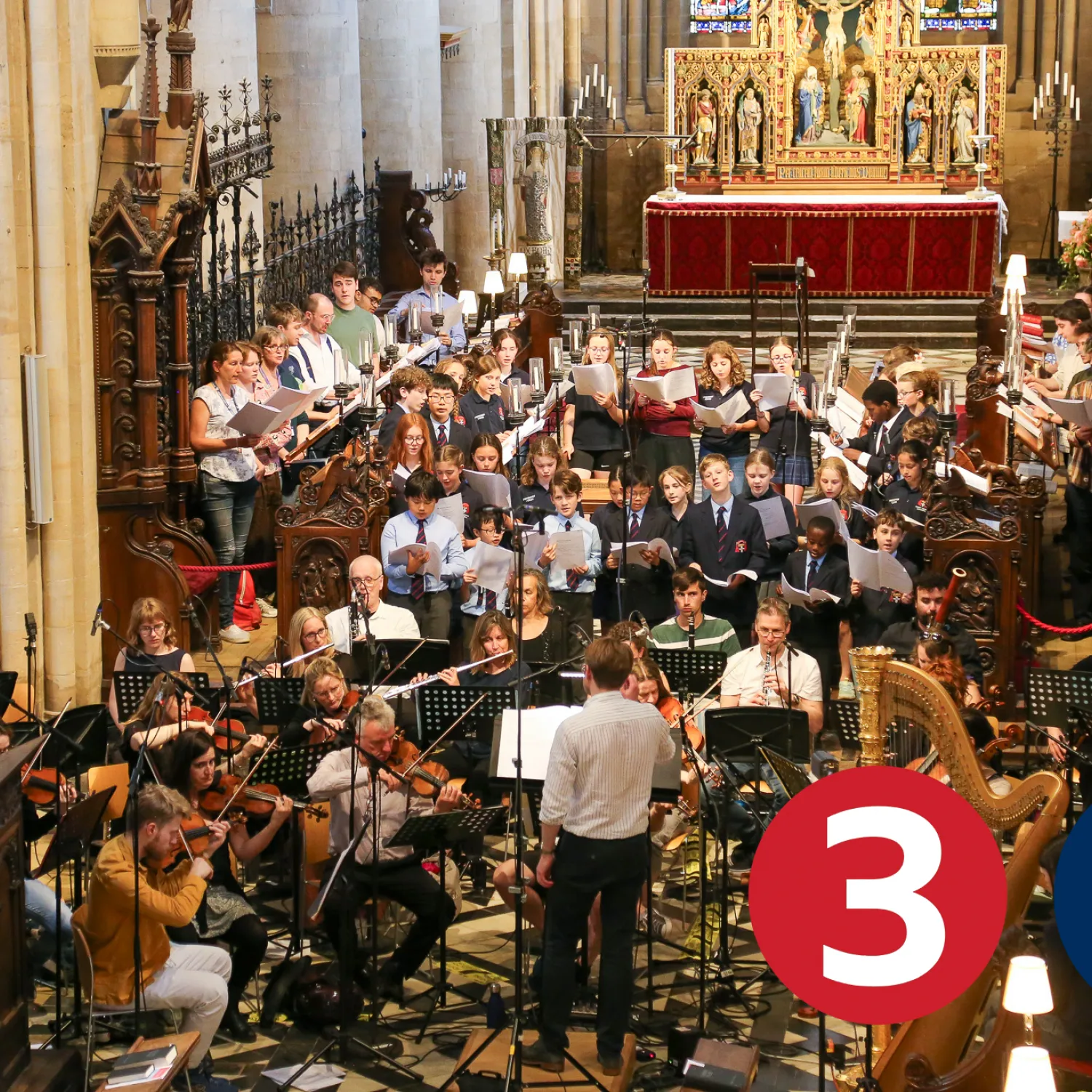 Peter holder conducts the Cathedral Choir, frideswide voices and an orchestra in the Cathedral, surrounded by recording microphones