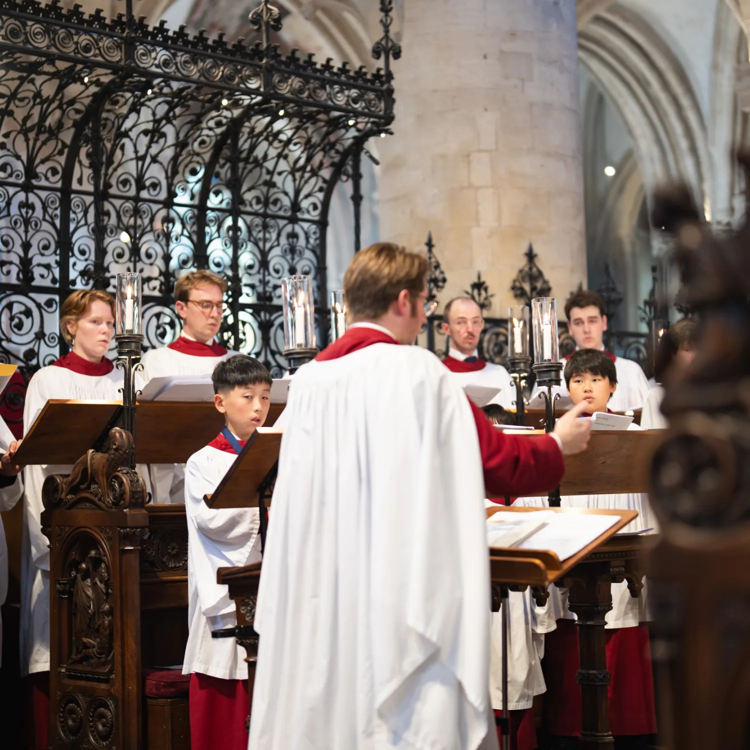 Peter Holder conducts the choir during the 500th anniversary Vespers service